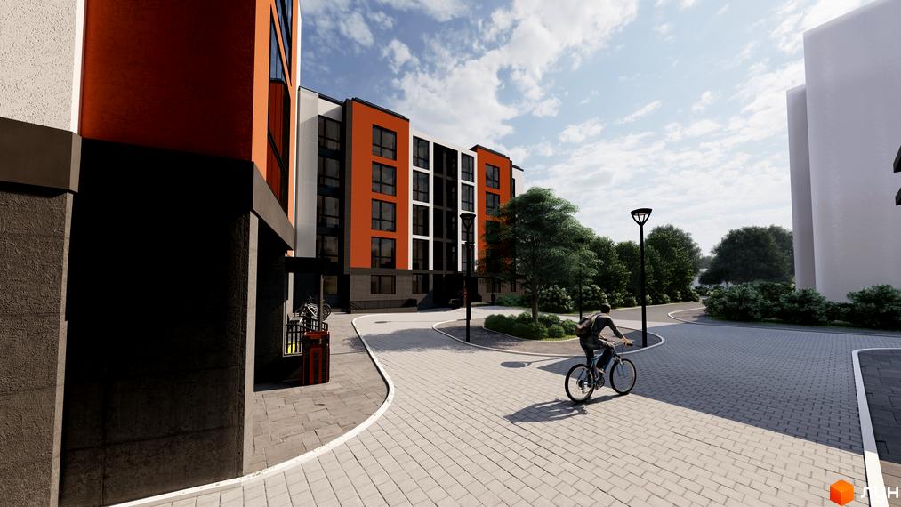 Житловий комплекс Флагман з яскравим фасадом та доглянутою прибудинковою територією, де є велодоріжки та зелені зони.