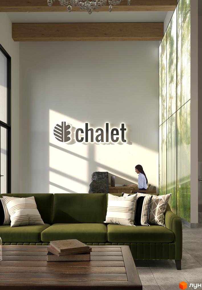 Інтер'єр житлового комплексу Chalet з диваном та логотипом компанії. Сучасний дизайн та комфорт для вашого життя.