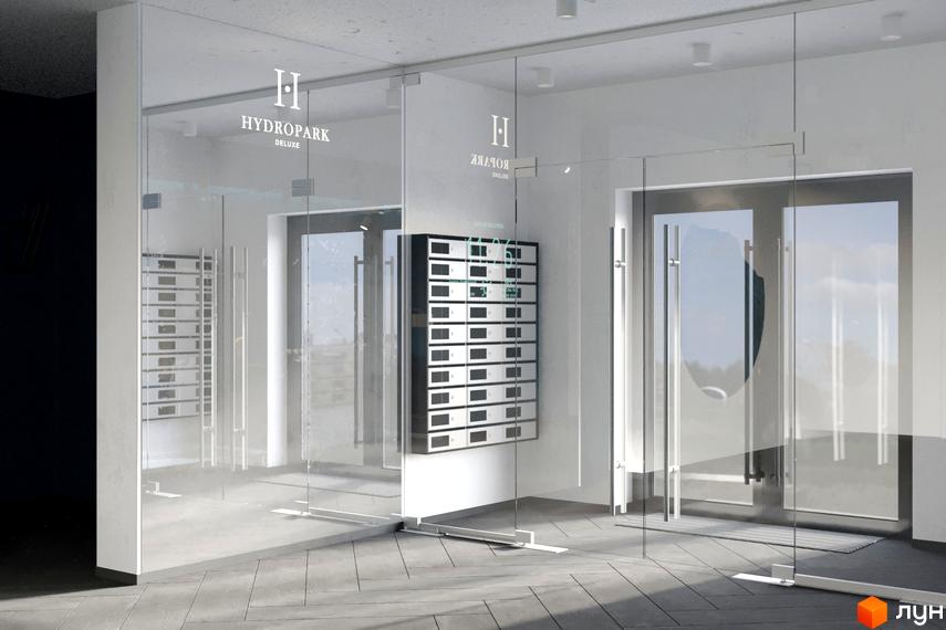 Вхідна група житлового комплексу HydroPark DeLuxe: прозорі скляні двері та поштові скриньки у вестибюлі.