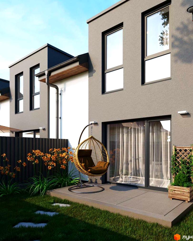 Зовнішній вигляд таунхаусу Sttk #10 з терасою та зоною відпочинку. На подвір'ї газон, декоративні рослини та підвісне крісло.