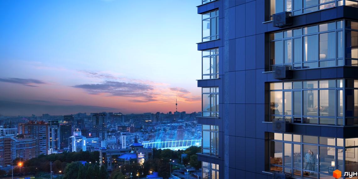 Зовнішній вигляд новобудови ЖК Maxima Residence на тлі вечірнього міста. Сучасний житловий комплекс з панорамними вікнами та балконами.