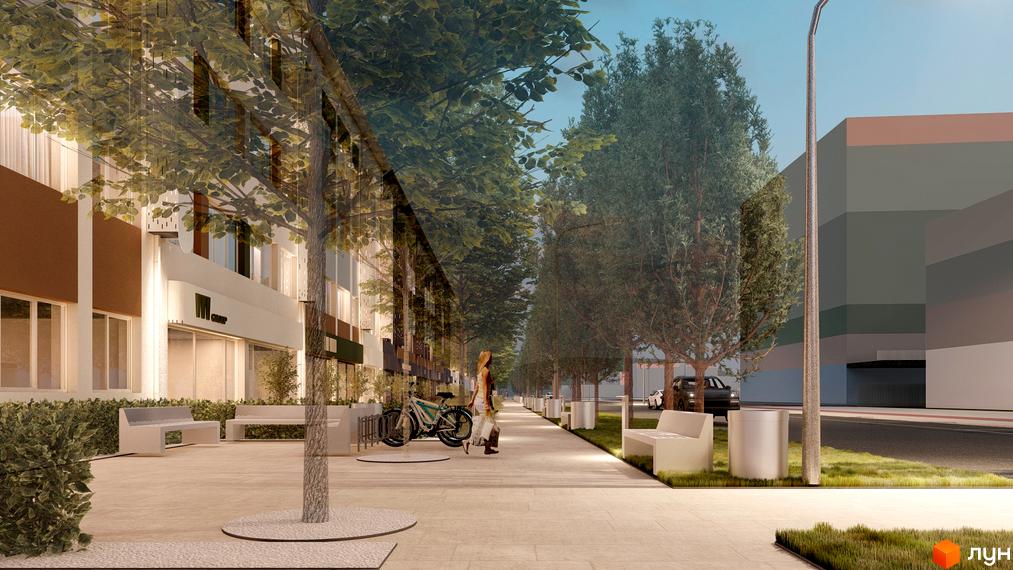 Фасад Комплексу Тиса Renovation має коричневі та світлі панелі з великими вікнами. Перед ним розташований широкий пішохідний бульвар з деревами, лавками та велопарковкою.