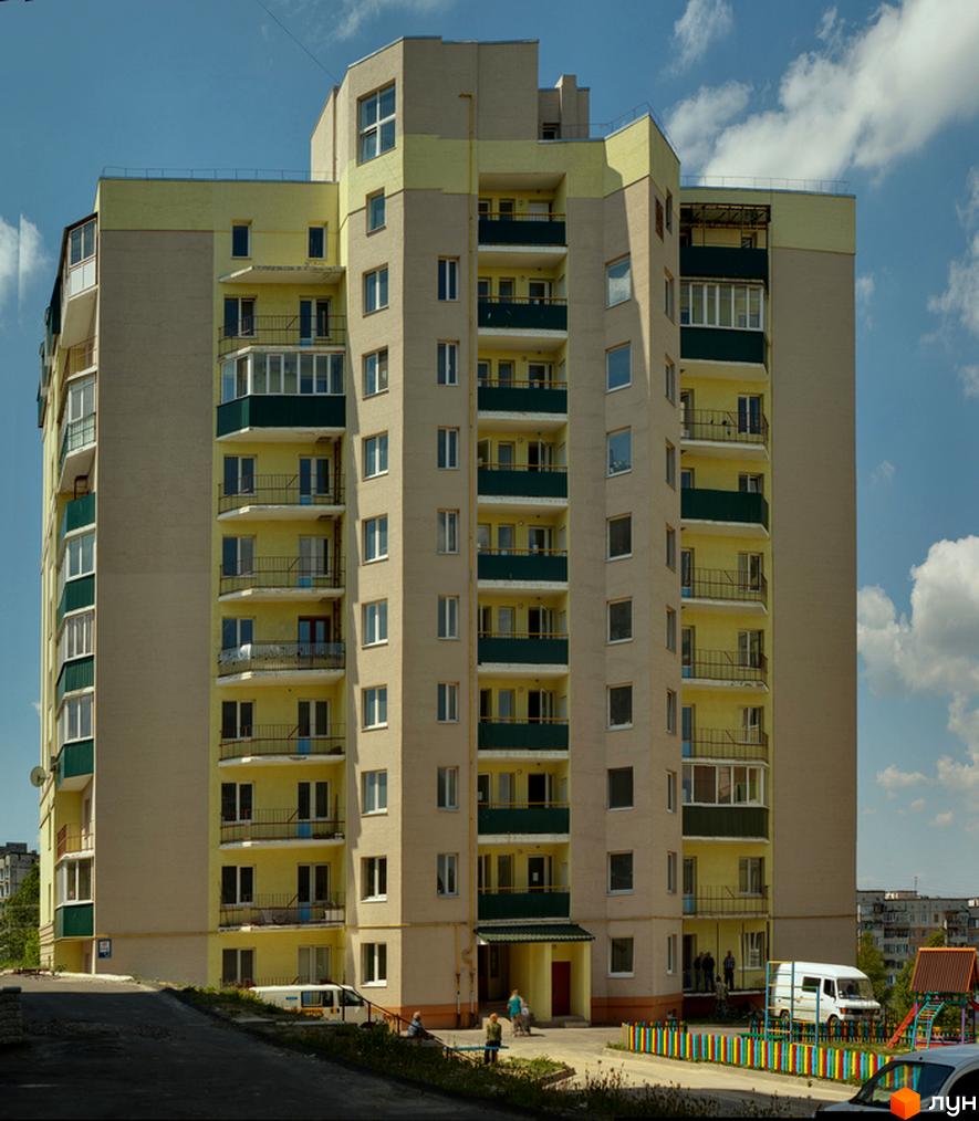 Житловий комплекс на вул. Черняка, 26-28 з балконами та прибудинковою територією, де розташовані дитячі майданчики.