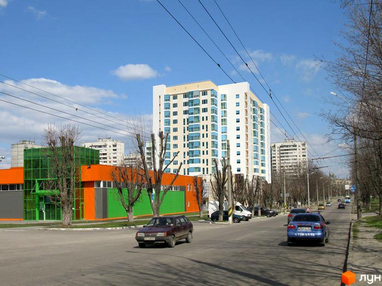 Житловий комплекс на проспекті Петра Григоренка, 18а, з сучасним фасадом та прибудинковою територією. Вид на будівлю та навколишню інфраструктуру.