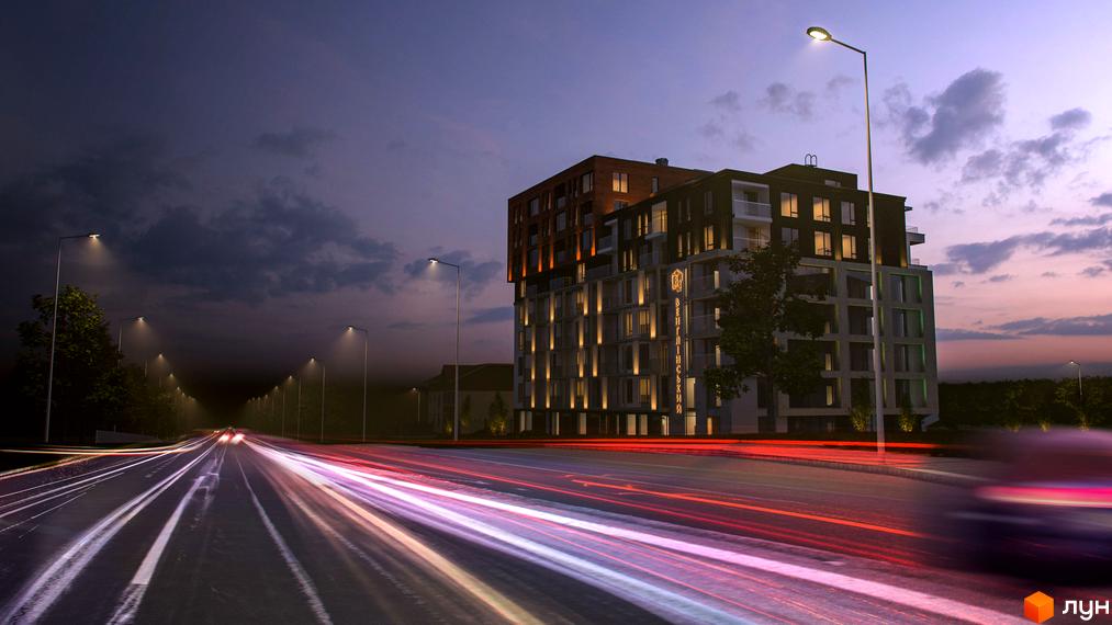 Житловий комплекс Венґлінський: багатоповерхова будівля з освітленими фасадами та вікнами, розташована біля широкої дороги з світловими смугами від транспорту та вуличними ліхтарями.