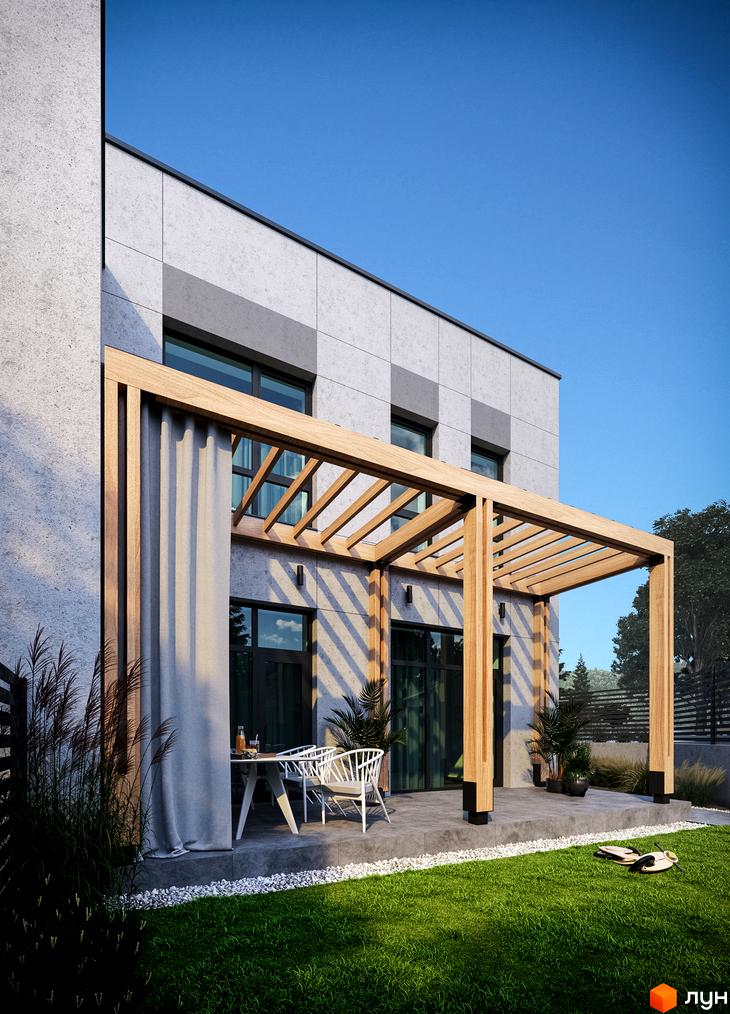 Фасад Таунхаусів FIRST з сірими панелями та великими вікнами. Перед будинком розташована дерев'яна пергола над патіо з меблями та зелений газон.