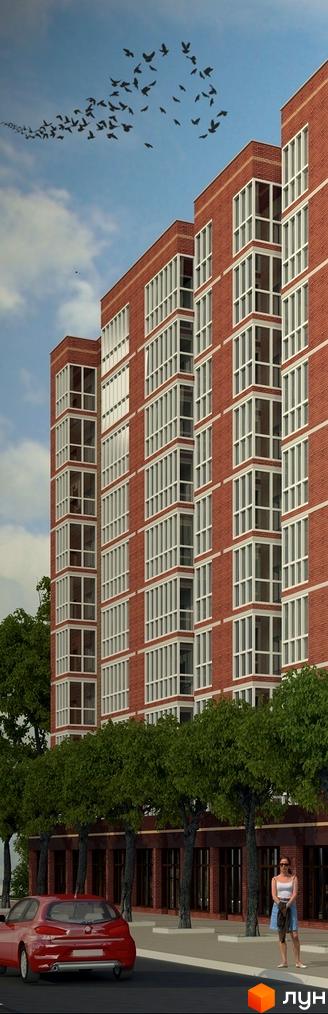 Зображення фасаду Житлового комплексу Шевченківський. Багатоповерховий будинок з червоної цегли з великими вікнами та балконами.