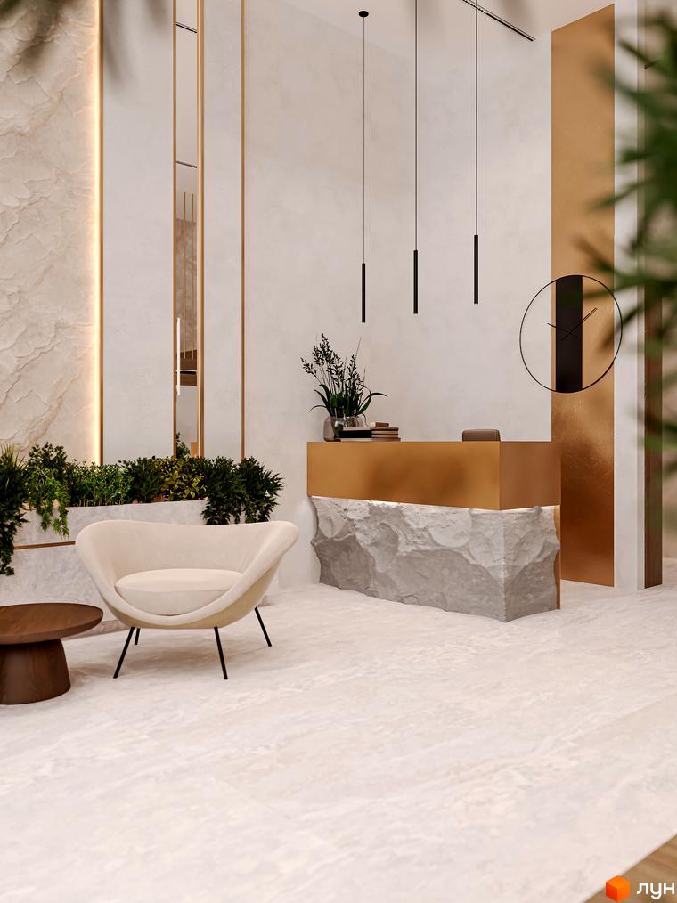 Інтер'єр рецепції OLEGIV Boutique Residence з золотим ресепшн та кам'яною стійкою. Затишне крісло та столик поруч із зеленню.