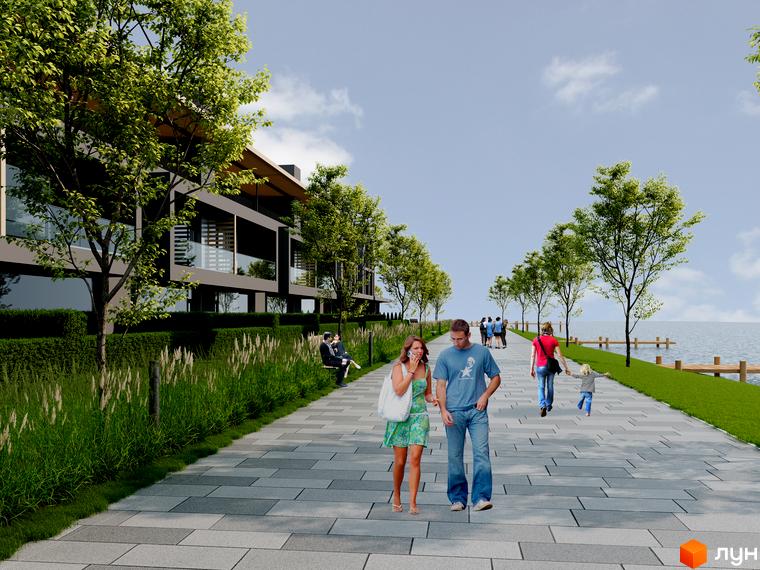 Комплекс КМ Concept Riviera з темним фасадом та скляними балконами, розташований вздовж набережної з пішохідною зоною та деревами.