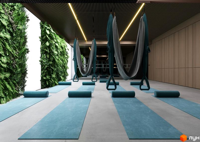 Зал для йоги в ЖК Signature з килимками та гамаками для повітряної йоги. Зелені стіни з рослинами створюють атмосферу спокою та гармонії.