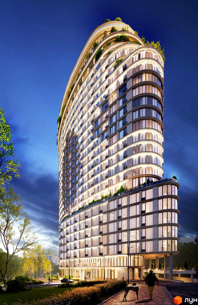 Вид на новобудову ЖК Delrey з вигнутим фасадом та численними вікнами, освітленими ввечері. На передньому плані – доглянута прибудинкова територія з деревами та пішохідною доріжкою.