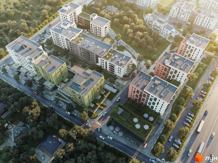 Житловий комплекс HYGGE LUX з багатоповерховими будинками та зеленою прибудинковою територією. На зображенні видно фасади будівель, балкони та дерева.