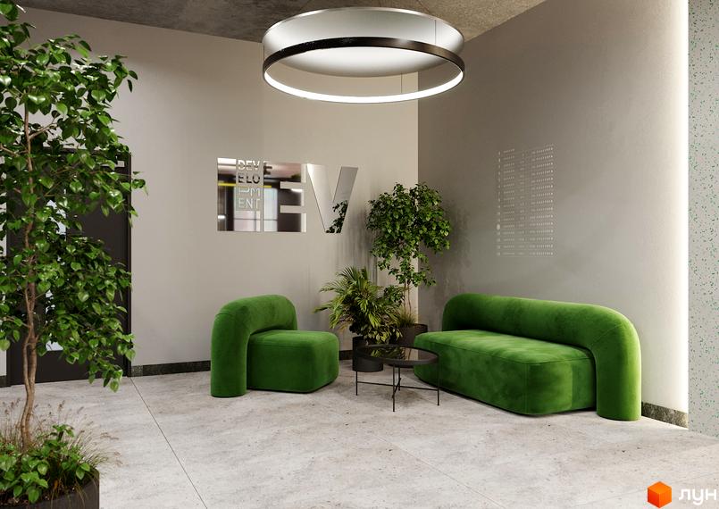 Інтер'єр зони очікування в житловому комплексі PERFECT LIFE з двома зеленими диванами та журнальним столиком. На стіні логотип та рослини.