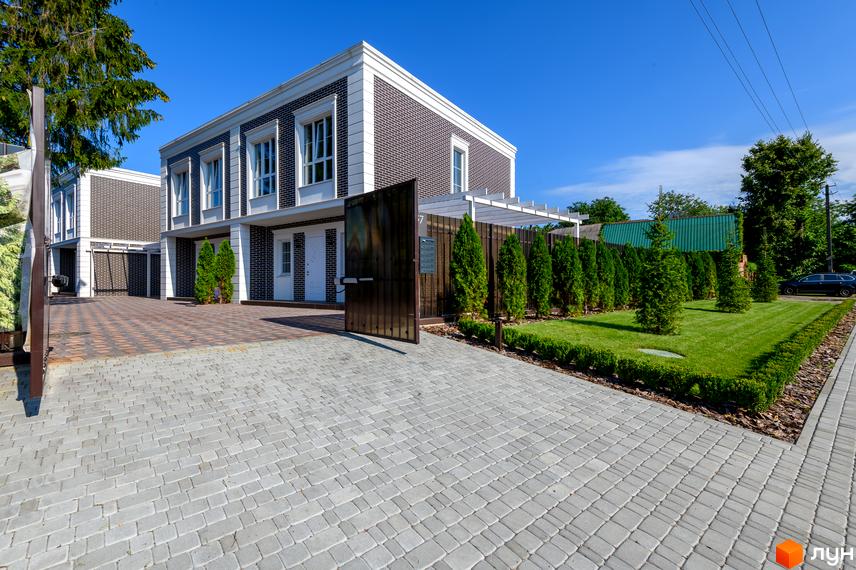 Feofaniya Home - двоповерхові таунхауси з цегляним фасадом та акуратним ландшафтним дизайном. Прибудинкова територія з бруківкою та зеленими насадженнями.
