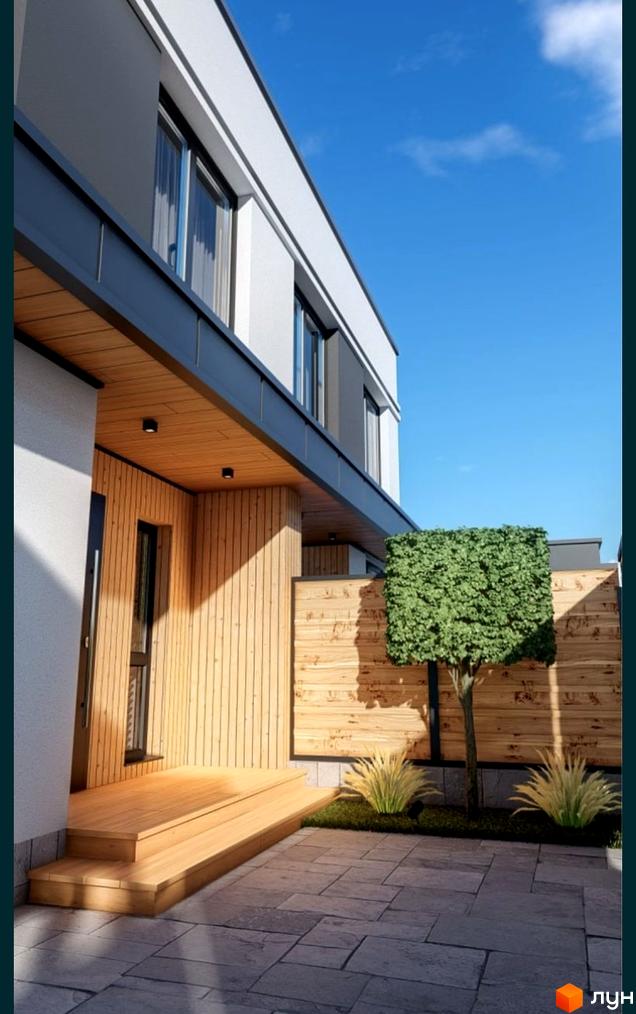 Зовнішній вигляд будинку КМ Kulbaba Dupleks Sofia з дерев'яними елементами та вимощеною терасою. На прибудинковій території доглянутий газон та декоративне дерево.