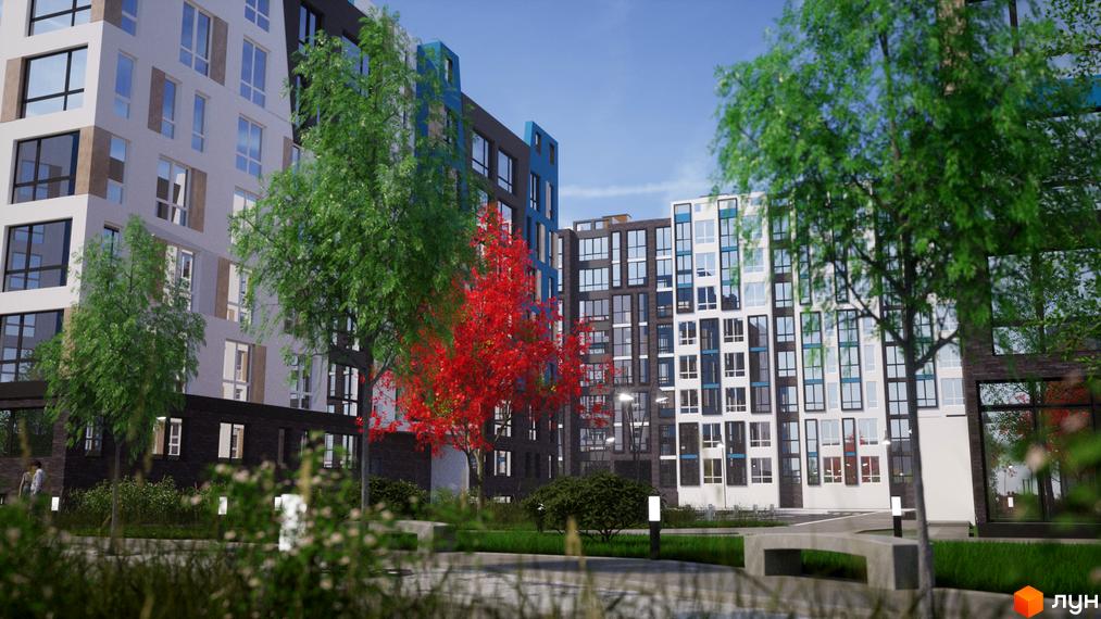 Багатоповерхові будинки Житлового комплексу One Family з різнокольоровими фасадами та великими вікнами. Навколо облаштована зелена територія з деревами та доріжками.