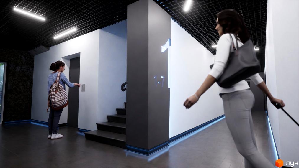 Інтер'єр холу Житлового комплексу One Family з ліфтом та сходами. На стіні номер поверху та жінка з валізою.