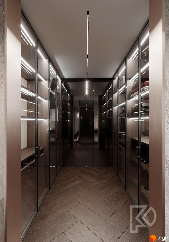 Просторий гардероб з скляними дверима та підсвічуванням у клубному будинку Graf. Сучасний дизайн інтер'єру з дерев'яною підлогою.