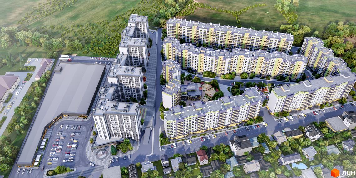 Житловий комплекс Щасливий Grand з висоти пташиного польоту, що демонструє сучасну архітектуру та доглянуту прибудинкову територію з дитячими майданчиками та парковками.