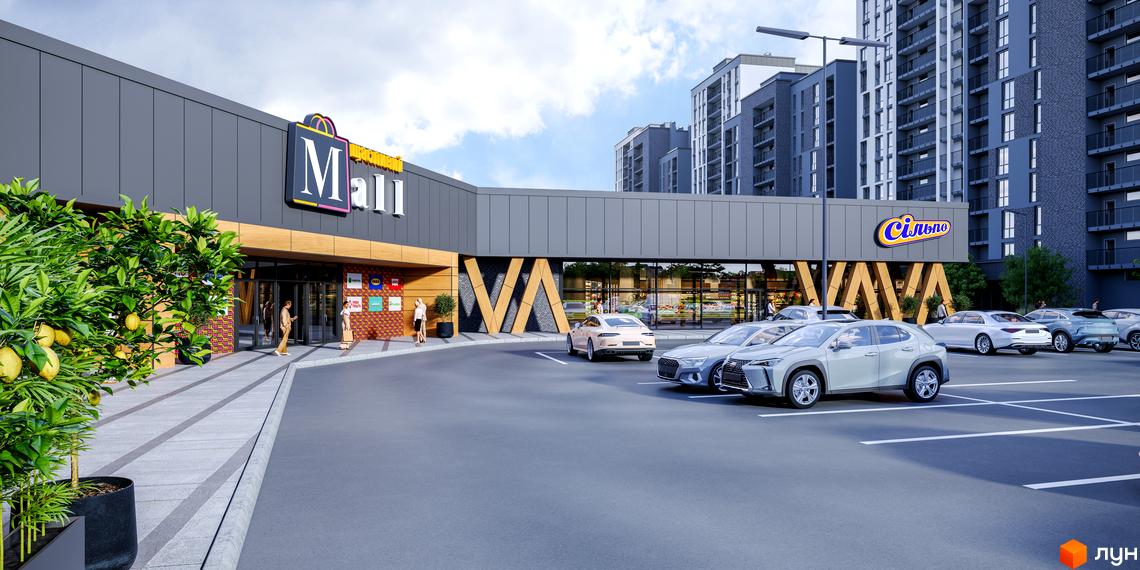 Зовнішній вигляд торгово-розважального центру ЖК Щасливий Grand з парковкою та зеленими насадженнями. Сучасна архітектура фасаду та зручна прибудинкова територія для мешканців.