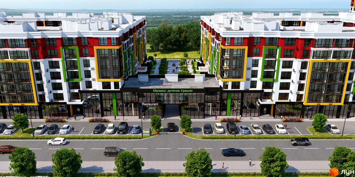 Зображення фасаду багатоповерхового будинку ЖК Добре Місто 2 з великими вікнами та яскравими кольоровими блоками. На передньому плані парковка та дорога з зеленими насадженнями.