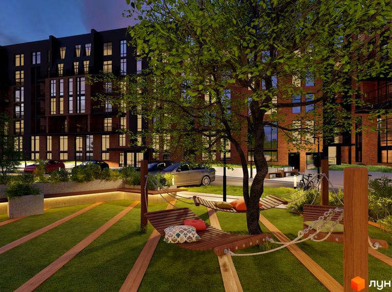 Зображення фасаду багатоповерхового будинку ЖК Гринвіч Парк з цегляними та темними секціями, з зоною відпочинку з гамаками та деревом на прибудинковій території.