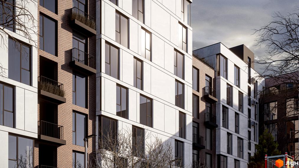 Зовнішній вигляд житлового комплексу Panorama з цегляними та білими фасадами, великими вікнами та балконами. Навколо будинку зелені насадження та дерева.