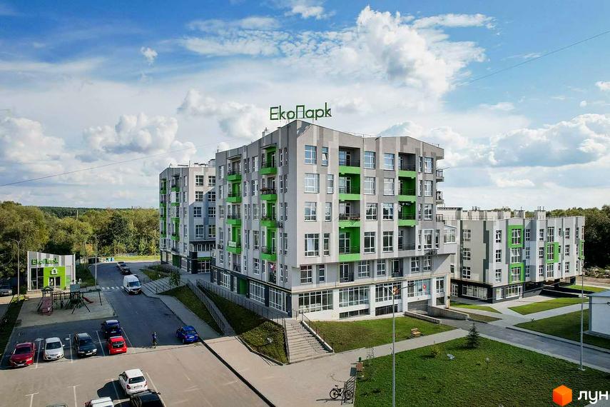 Житловий комплекс ЕкоПарк – це сучасна новобудова з яскравими зеленими балконами та великою кількістю вікон. Територія навколо будинку облаштована дитячим майданчиком та місцями для паркування.