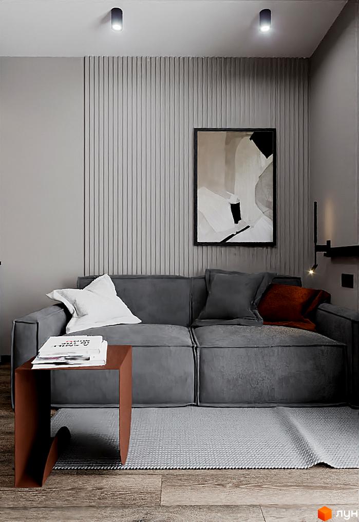 Інтер'єр кімнати в Житловому комплексі SOLOWAY: сірий диван з подушками, картина на стіні та столик з книгами. Затишний куточок для відпочинку.