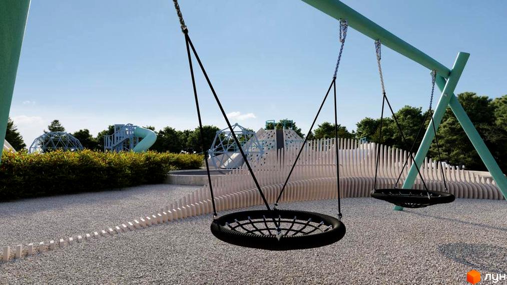 Дитячий майданчик з гойдалками та ігровими комплексами на території житлового комплексу КМ Riviera City Park. Зелена зона з деревами та кущами.