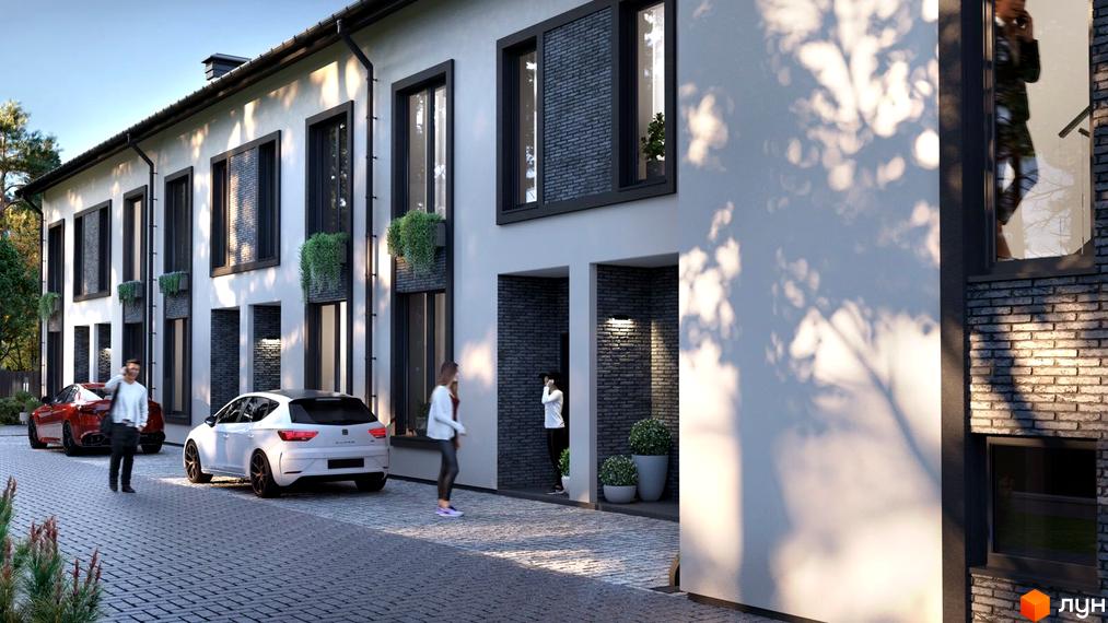 Фасад житлового комплексу на вул. Ярославська, 26в, з білою штукатуркою та темними вікнами. Поруч припарковані автомобілі та викладена бруківкою доріжка.