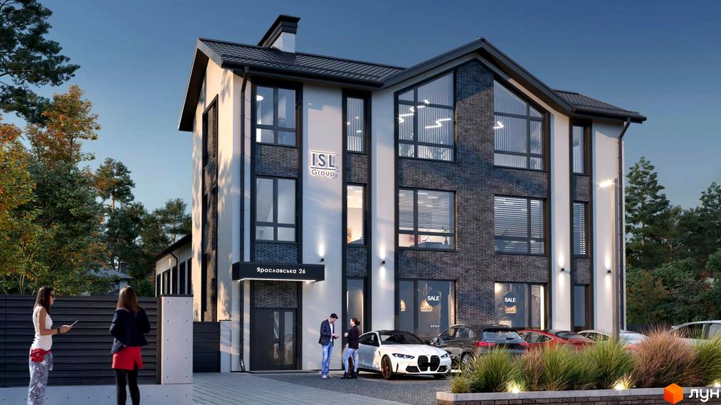 Будинок новобудови на вул. Ярославська, 26в з великими вікнами та цегляним фасадом. Поруч розташовані припарковані автомобілі та зелені насадження.
