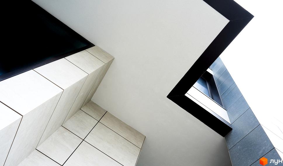 Фасад житлового комплексу Crystal Park Tower з геометричними елементами та великими вікнами. Зовнішній вигляд новобудови.