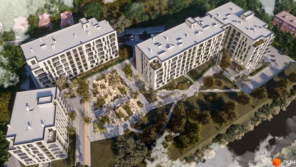 Житловий комплекс Набережний: вид зверху на три багатоповерхові будинки зі світлими фасадами та облаштованою прибудинковою територією з зеленими насадженнями та доріжками.