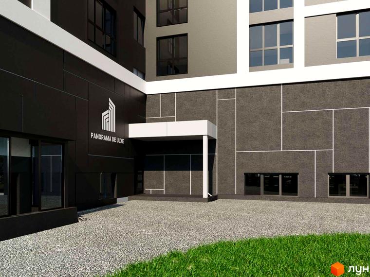 Новобудова ЖК PANORAMA DE LUXE з темним фасадом та білими елементами. Прибудинкова територія з гравійним покриттям та зеленою галявиною.