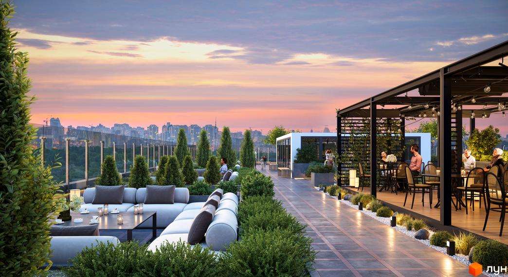 Житловий комплекс Central Hills: комфортний відпочинок на терасі з панорамним видом на місто. Затишна зона з диванами та столиками для гостей.