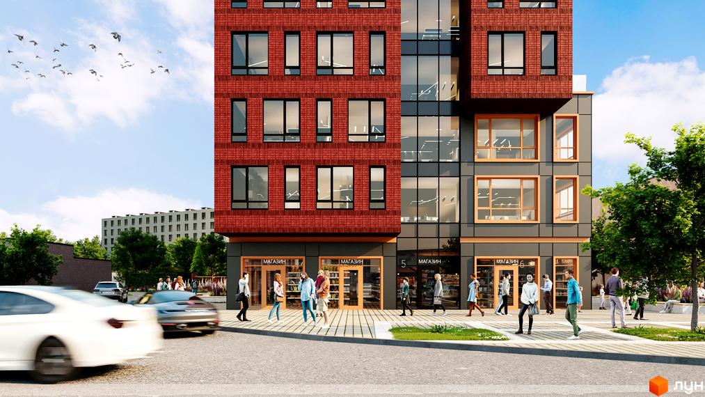 Висотна будівля з червоної цегли та скляними фасадами. На першому поверсі розташовані магазини, навколо будівлі тротуар та зелені насадження.