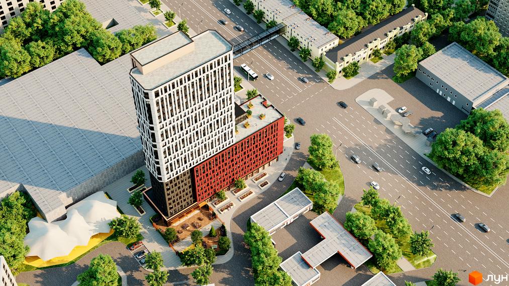 Багатоповерховий будинок БФК Industrial з біло-червоним фасадом та благоустроєною прибудинковою територією з зеленими насадженнями та парковкою.