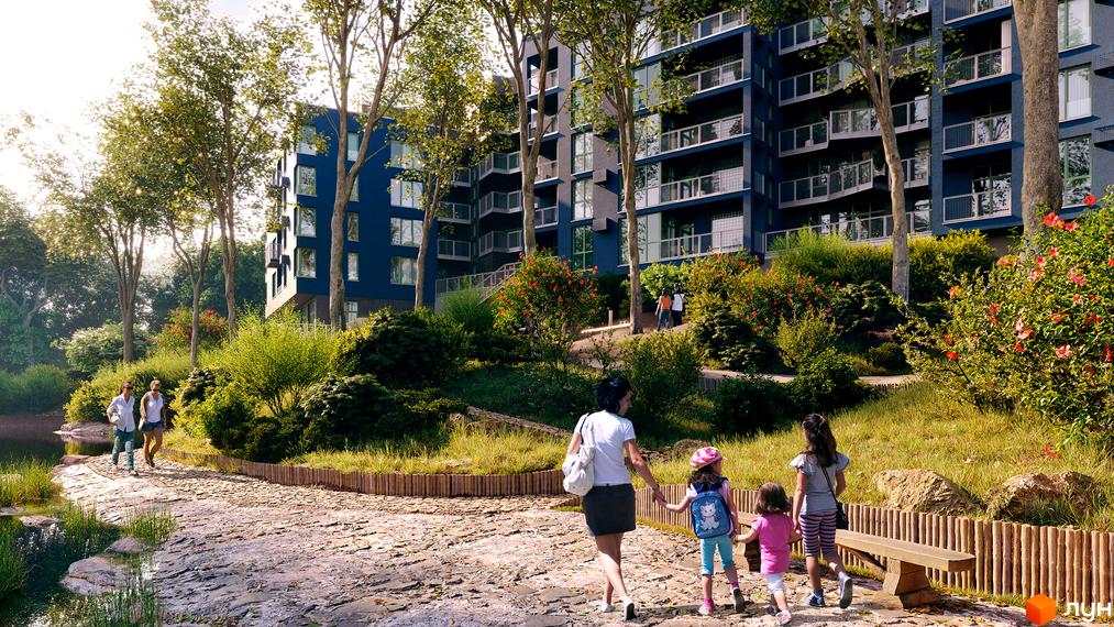 Житловий комплекс ПІД ЗОРЯМИ з синіми фасадами та балконами, оточений зеленою прибудинковою територією з деревами та квітами.