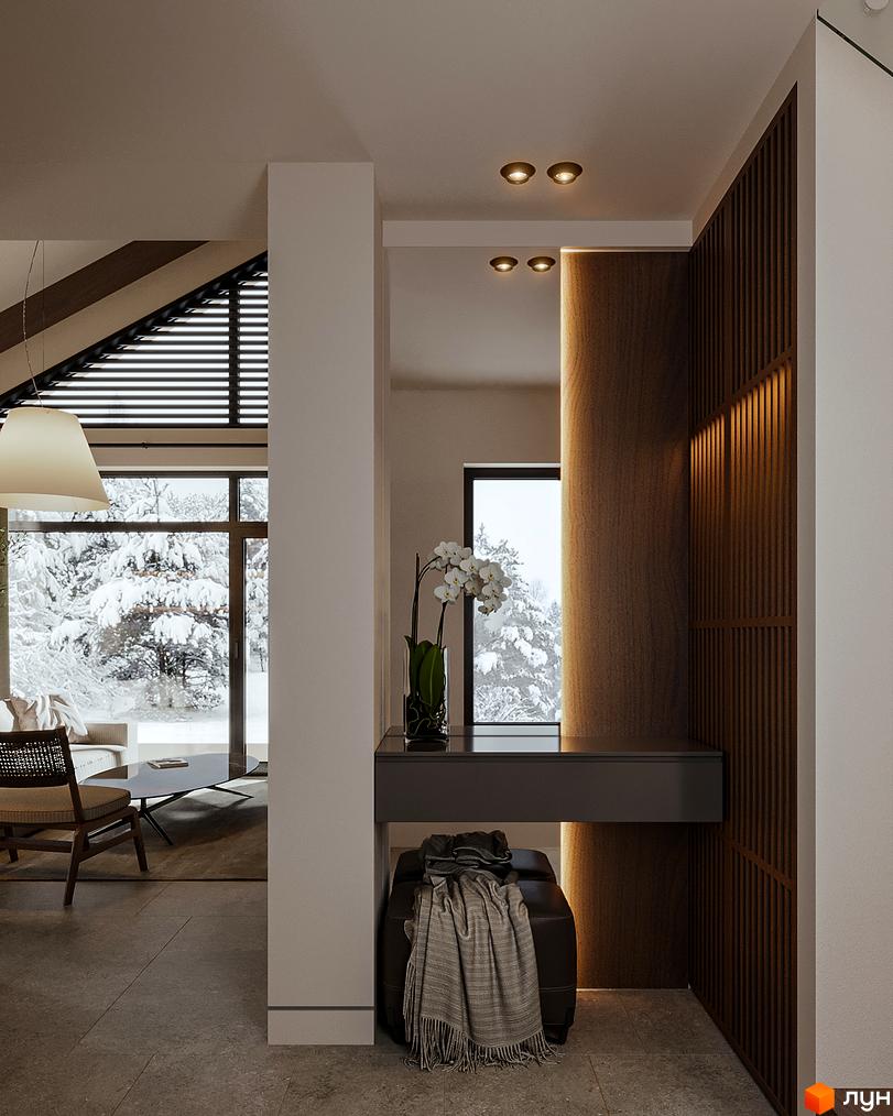 Інтер'єр будинку з великими вікнами та видом на засніжений ліс. У приміщенні є консоль з квітами, пуф та дерев'яні панелі.