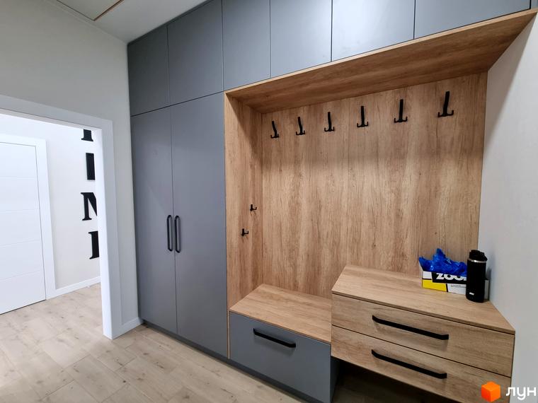 Котеджне містечко Сонячний: сучасний передпокій з сірими шафами, дерев'яною нішею для одягу та зручною лавою. Стильний дизайн інтер'єру новобудови.