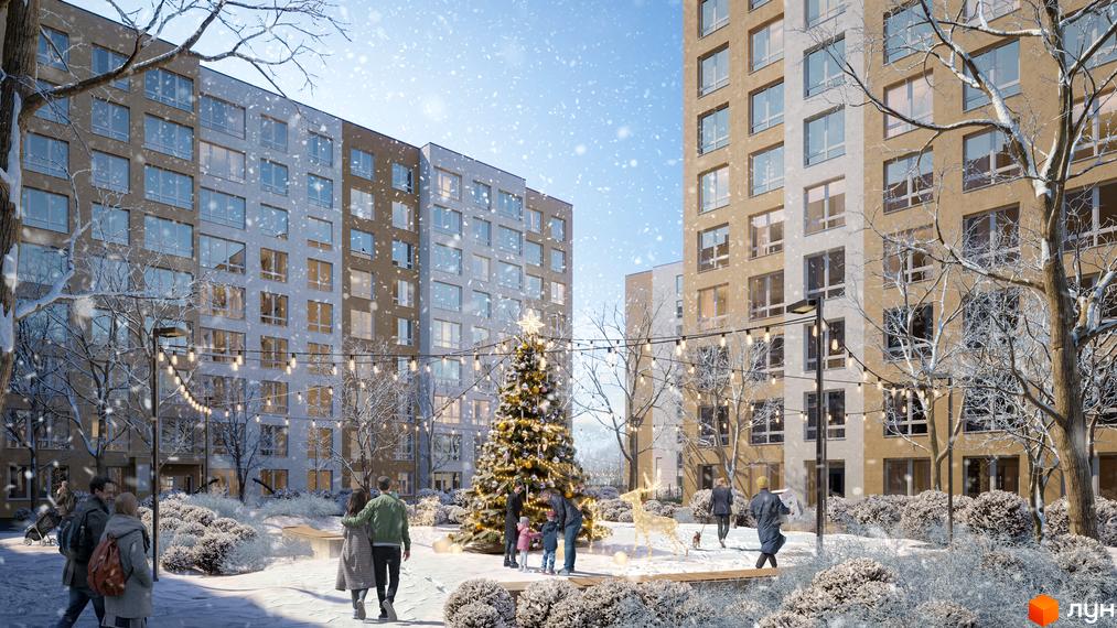 Житловий комплекс Нова Буча взимку з новорічною ялинкою та різдвяними прикрасами. Засніжена прибудинкова територія з деревами та людьми.