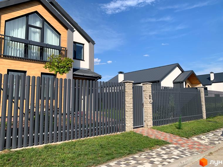 Котеджне містечко КМ Європа: фасади будинків з панорамними вікнами, огороджена територія з парканом та воротами.