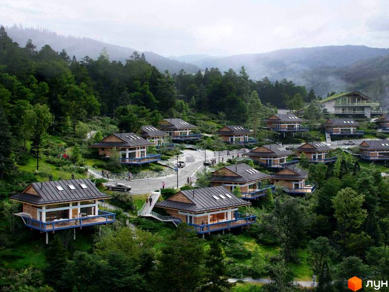 Котеджне містечко КМ GORA: дерев'яні будинки з блакитними терасами на схилі гори, оточені зеленню. Навколо комплексу - мальовнича природа та доглянута територія.