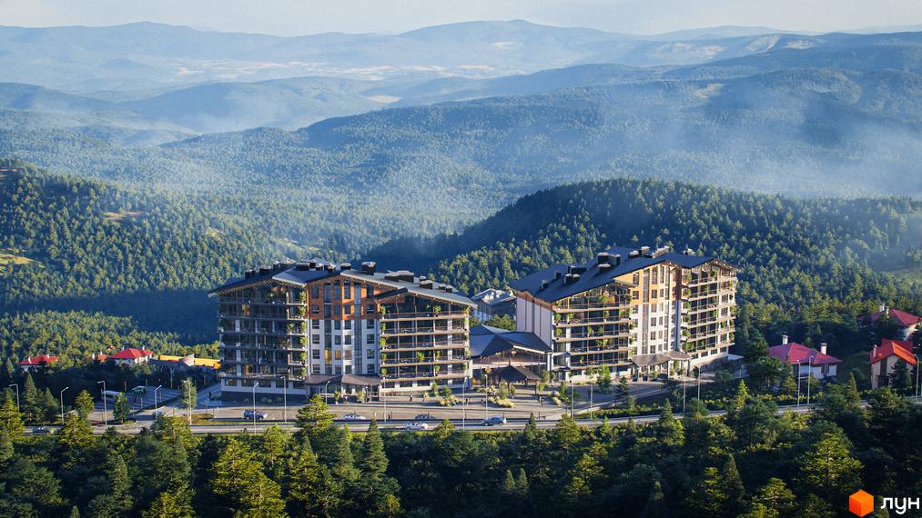 Apartel Skhidnytsya - сучасний житловий комплекс у Карпатах, що гармонійно вписується в гірський ландшафт. Комплекс має багатоповерхові будівлі з балконами та терасами, оточені лісом.