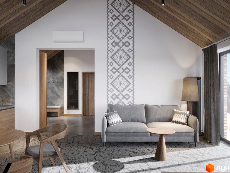Інтер'єр вітальні в Apartel Shayan Villas з сірим диваном та дерев'яними меблями. На стіні декоративний орнамент.
