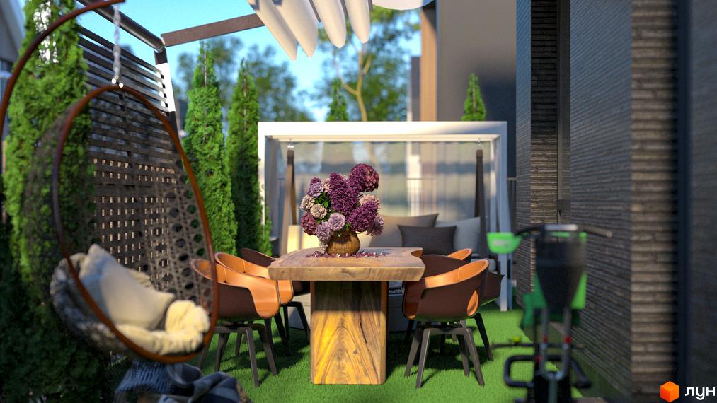 Затишна тераса з плетеним кріслом та обідньою зоною в КМ Garden Village Ozerne. Зелена прибудинкова територія з рослинами та меблями.