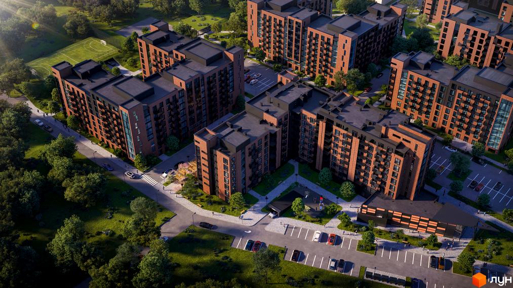 Житловий комплекс Royal Town з цегляними фасадами та чорними дахами, оточений зеленню та з пішохідними доріжками.