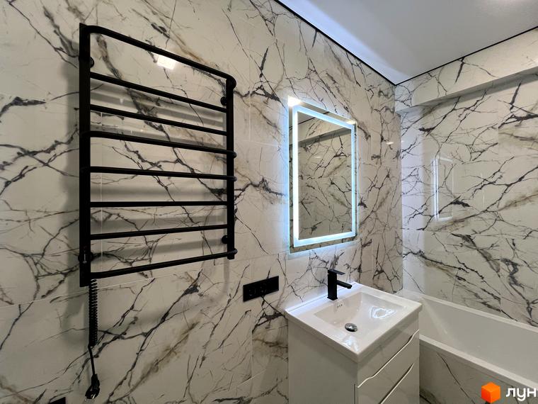 Сучасний дизайн ванної кімнати з мармуровою плиткою, підсвіченим дзеркалом, чорним полотенцесушителем та білою раковиною.