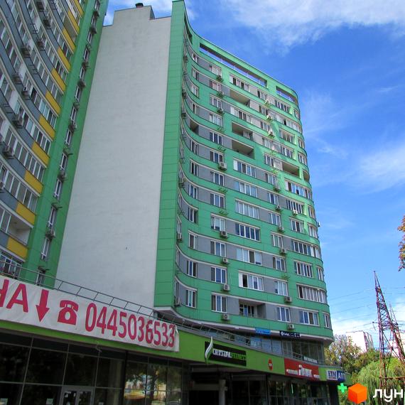 Багатоповерховий житловий будинок Житловий комплекс Паркове місто з фасадом зеленого та сірого кольорів, численними вікнами та комерційними приміщеннями на першому поверсі.